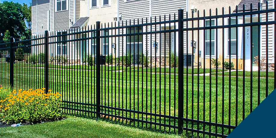 Black aluminum spear-top fence with three rails along a residential lawn
