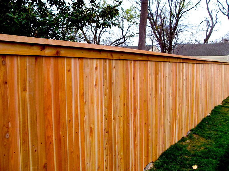 Cedar privacy fence with cap and trim, natural finish, in a north Atlanta backyard