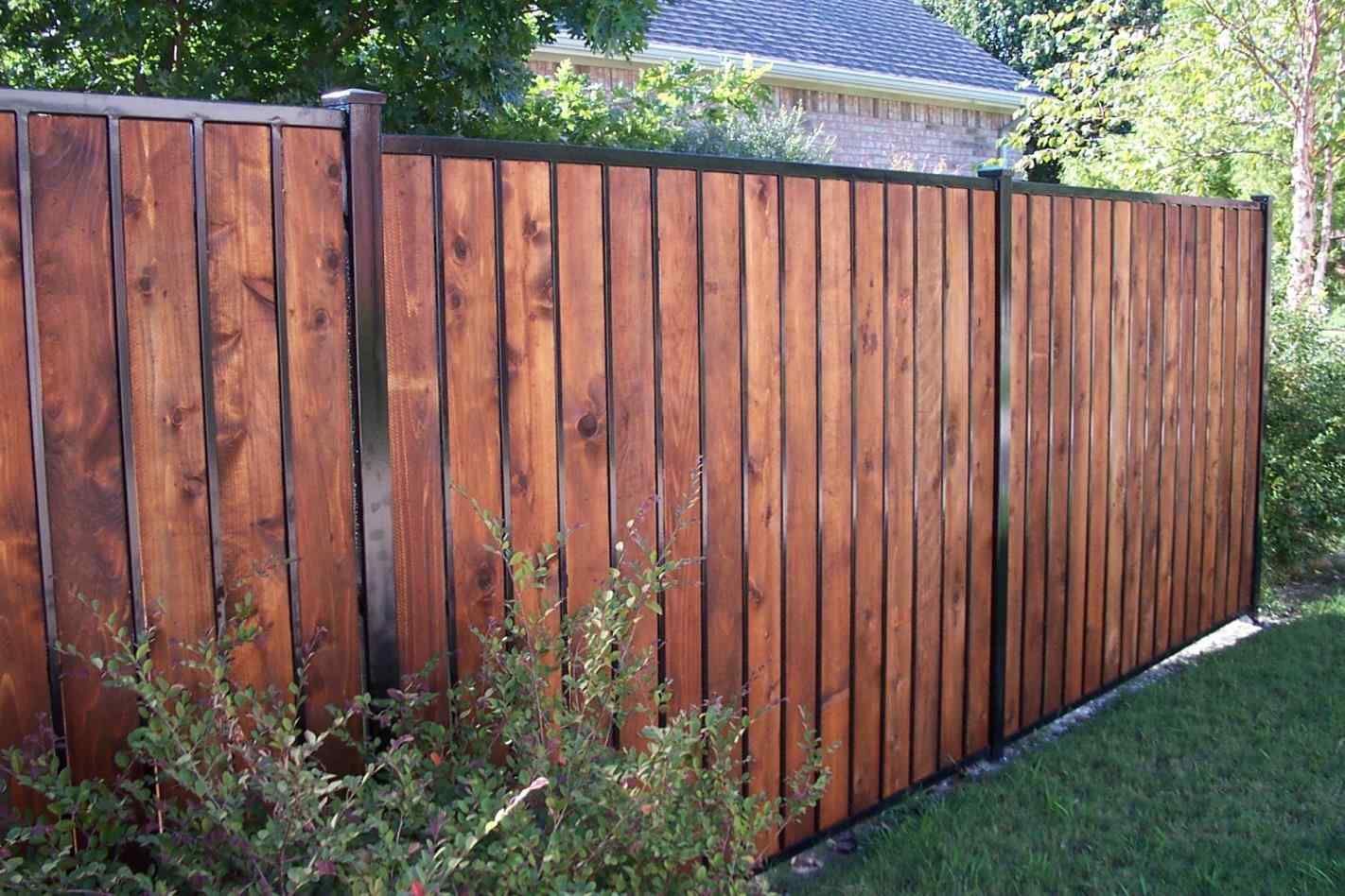 Modern cedar privacy fence built into a black powder-coated metal frame