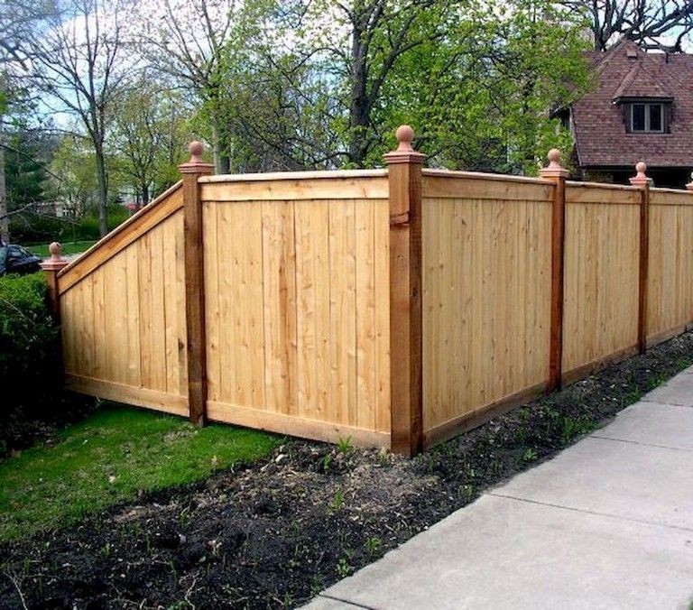 Cedar privacy fence with cap, trim, and decorative French gothic post caps