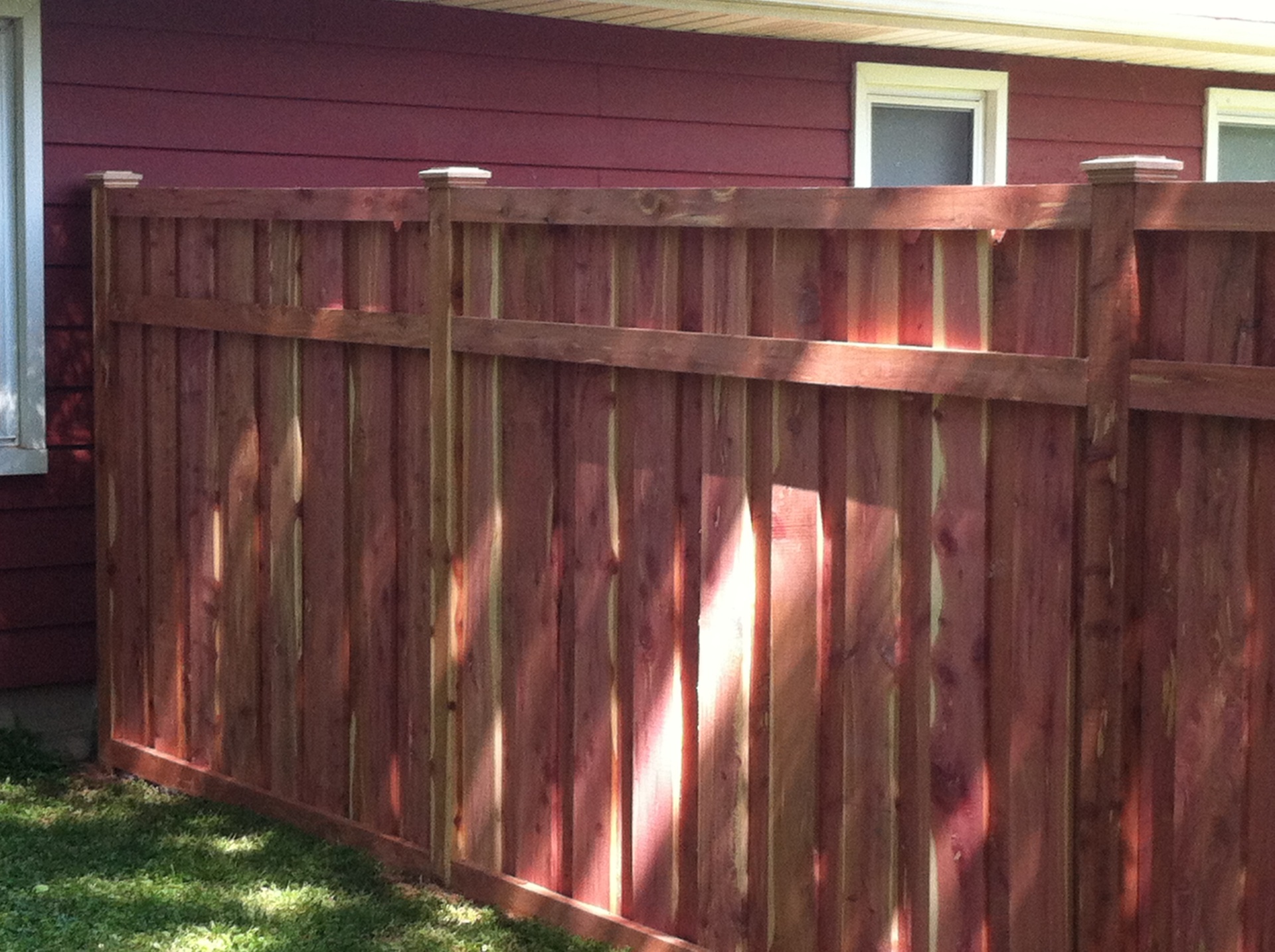 Eastern red cedar board-on-board privacy fence with cap and trim, six feet tall